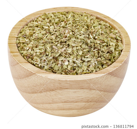 Dried oregano leaves in a small wooden bowl isolated. Useful for culinary, cooking, spice, and herb concepts. High-quality seasoning ingredients for food photography. 136811794