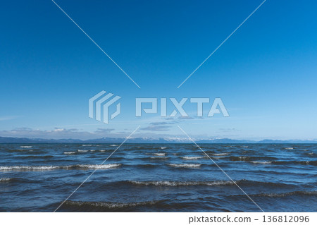 Lake Biwa in midwinter and the snowy mountains of Kohoku in the distance Lake Biwa in midwinter and the snowy mountains of Kohoku in the distance 136812096
