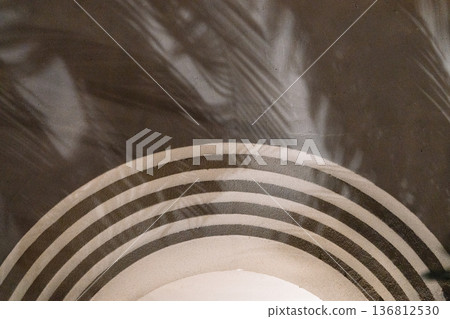 Minimalist background of arched wall illuminated by natural light and shadows of tree leaves Minimalist background of arched wall illuminated by natural light and shadows of tree leaves 136812530