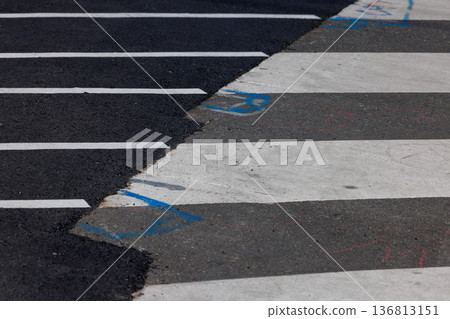 The boundary between the old and new asphalt and a crosswalk under repair The boundary between the old and new asphalt and a crosswalk under repair 136813151