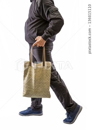 A man walking with a bag on a white background A man walking with a bag on a white background 136815110