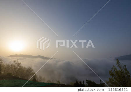 Mountains floating in a sea of clouds at dawn Mountains floating in a sea of clouds at dawn 136816321