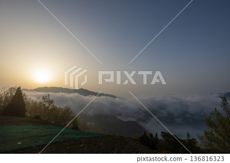Mountains floating in a sea of clouds at dawn Mountains floating in a sea of clouds at dawn 136816323