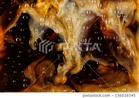 Macro shot of pouring milk into iced coffee 136816545