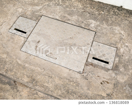 Industrial Metal Access Panels with Diamond Plate Pattern on Concrete Ground Industrial Metal Access Panels with Diamond Plate Pattern on Concrete Ground 136818089