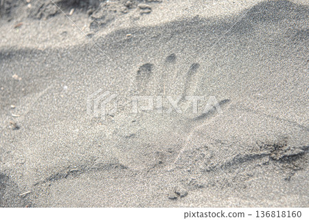 Handprints left on the sandy beach 136818160