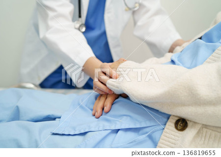 Asian doctor checking and treat elderly woman patient health in hospital. Asian doctor checking and treat elderly woman patient health in hospital. 136819655