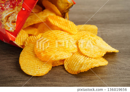 Potato chips , delicious BBQ seasoning spicy for crips, thin slice deep fried snack fast food. 136819656