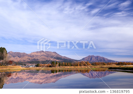 View of Mt. Nekodake and Mt. Takadake across the rural landscape of Minamiaso, Kumamoto Prefecture 136819795