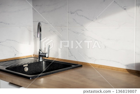 kitchen black sink with a sleek faucet kitchen black sink with a sleek faucet 136819807