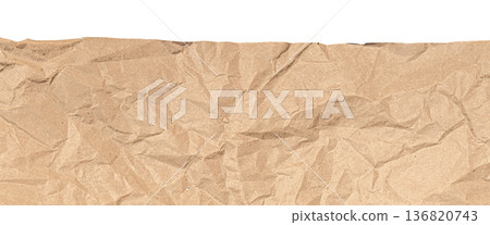 Crumpled brown paper background with ripped edge 136820743