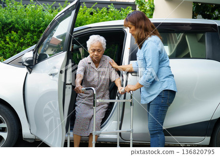Caregiver help Asian elderly woman disability patient use walker to get in car. Caregiver help Asian elderly woman disability patient use walker to get in car. 136820795