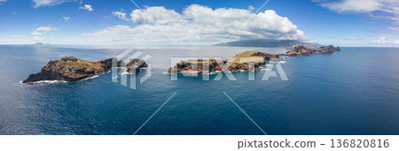 Drone panorama shows Point of Saint Lawrence with Ilheus do Farol lighthouse and Madeira behind Drone panorama shows Point of Saint Lawrence with Ilheus do Farol lighthouse and Madeira behind 136820816
