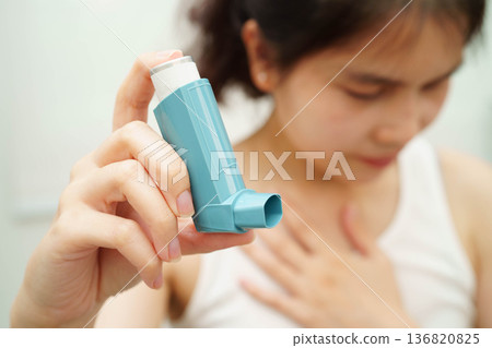 Asthma and chronic obstructive pulmonary disease COPD, Asian teenage using metered dose inhaler MDI. 136820825