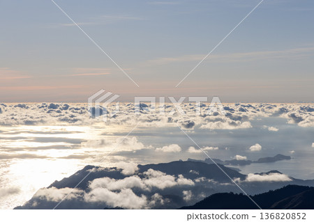 From Pico do Arieiro an Atlantic cloud sea opens as Sao Lourenco fades in haze and sunrise gleams From Pico do Arieiro an Atlantic cloud sea opens as Sao Lourenco fades in haze and sunrise gleams 136820852