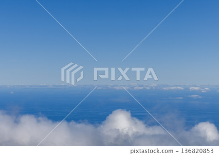 Low clouds hover over a blue sea horizon creating an airy minimal background Low clouds hover over a blue sea horizon creating an airy minimal background 136820853