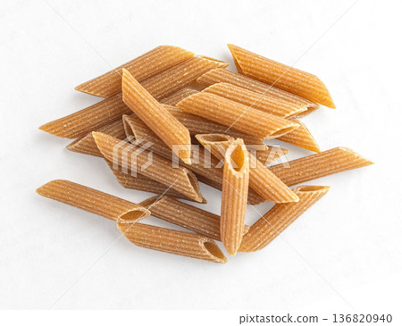Whole wheat penne pasta pile for healthy meal Whole wheat penne pasta pile for healthy meal 136820940