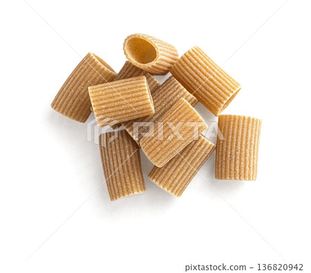 Dry whole wheat rigatoni pasta heap isolated on white Dry whole wheat rigatoni pasta heap isolated on white 136820942