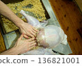 Person stuffing raw turkey Thanksgiving real home kitchen gourmet from scratch food prep 136821001