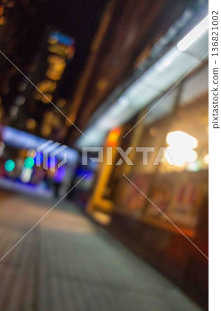 Blurred and crooked nightime city street intoxication drunk DUI concept 136821002