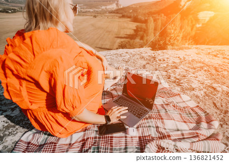 Woman Working on Laptop with a Stunning View Woman Working on Laptop with a Stunning View 136821452