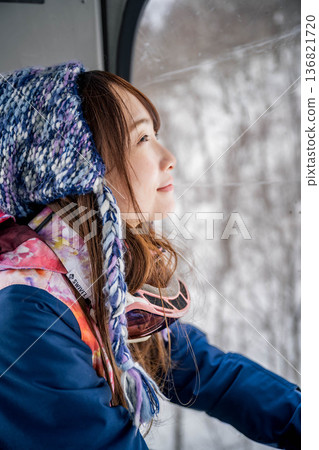 Young woman riding a vehicle to enjoy winter sports Young woman riding a vehicle to enjoy winter sports 136821720