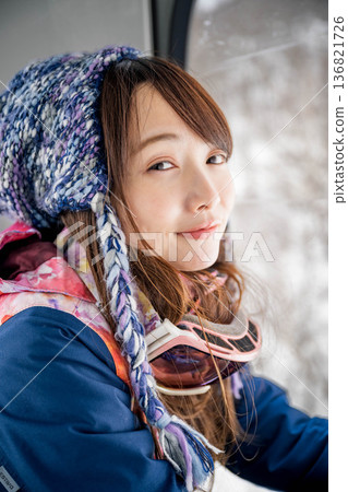 Young woman riding a vehicle to enjoy winter sports Young woman riding a vehicle to enjoy winter sports 136821726