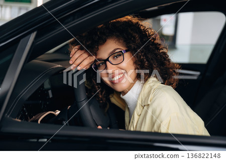Feeling good, sitting and smiling. Happy woman is sitting in the car Feeling good, sitting and smiling. Happy woman is sitting in the car 136822148