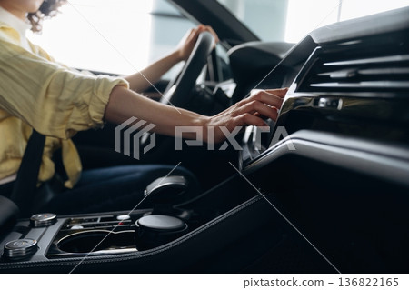 Side close up view of woman that is sitting in the car Side close up view of woman that is sitting in the car 136822165