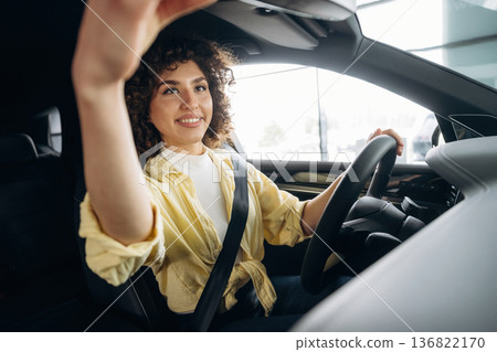 Happy woman is sitting in the car Happy woman is sitting in the car 136822170