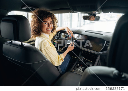 Feeling good, sitting and smiling. Happy woman is sitting in the car Feeling good, sitting and smiling. Happy woman is sitting in the car 136822171