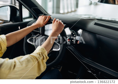 Side close up view of woman that is sitting in the car Side close up view of woman that is sitting in the car 136822172