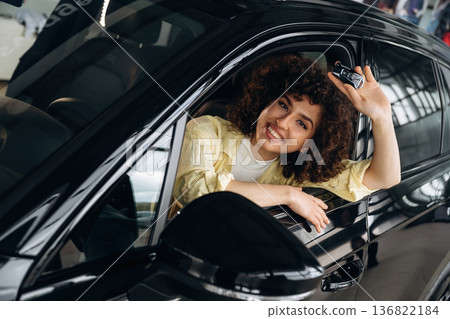 Happy woman is sitting in the car Happy woman is sitting in the car 136822184