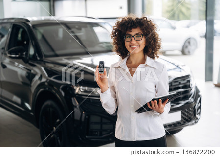 Female employee is in the car retail shop 136822200