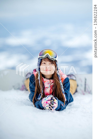 年輕女子在山坡頂端享受滑雪的樂趣 年輕女子在山坡頂端享受滑雪的樂趣 136822284