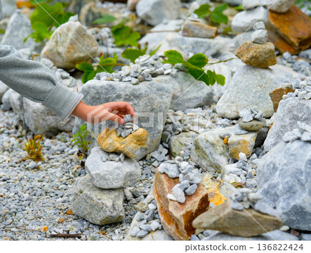 Relaxed spiritually child's hand arrangement pebble tower. Yoga relax meditation Relaxed spiritually child's hand arrangement pebble tower. Yoga relax meditation 136822424