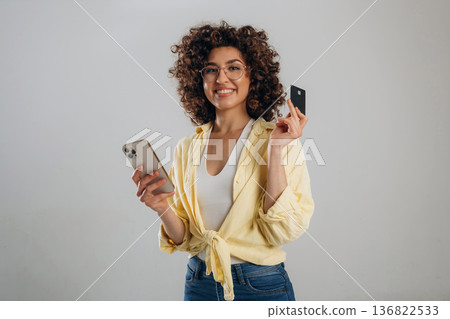 Online payment by using phone and credit card. Beautiful woman is in the studio Online payment by using phone and credit card. Beautiful woman is in the studio 136822533