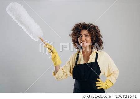 Housewife is ready to clean the house. Beautiful woman is in the studio Housewife is ready to clean the house. Beautiful woman is in the studio 136822571