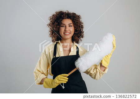 Housewife is ready to clean the house. Beautiful woman is in the studio 136822572