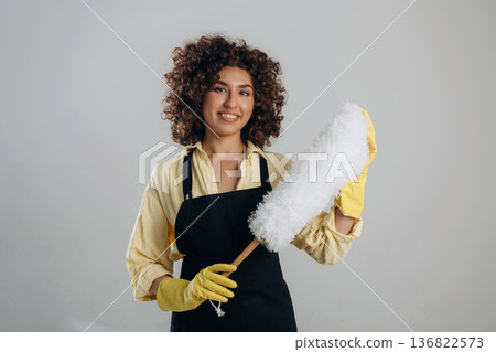 Housewife is ready to clean the house. Beautiful woman is in the studio 136822573