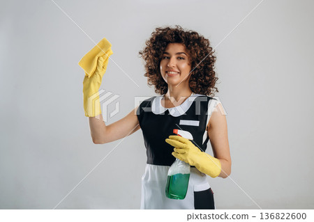 Smiling, conception of cleaning the home. Beautiful woman is in the studio Smiling, conception of cleaning the home. Beautiful woman is in the studio 136822600