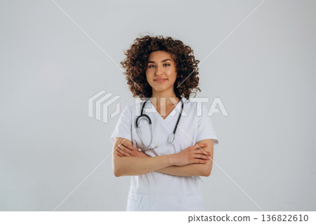 Standing, front view. Beautiful doctor woman is in the studio Standing, front view. Beautiful doctor woman is in the studio 136822610