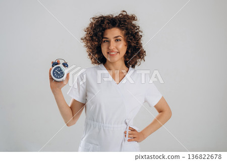 Clock, the time is ticking. Beautiful woman is in the studio 136822678