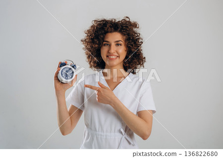Clock, the time is ticking. Beautiful woman is in the studio Clock, the time is ticking. Beautiful woman is in the studio 136822680