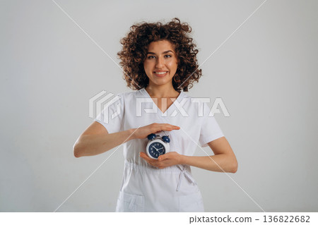 Clock, the time is ticking. Beautiful woman is in the studio Clock, the time is ticking. Beautiful woman is in the studio 136822682