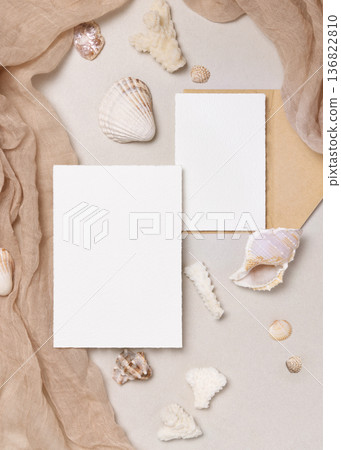 Blank paper cards mockup with seashells on beige stone, coastal wedding stationery, copy space Blank paper cards mockup with seashells on beige stone, coastal wedding stationery, copy space 136822810