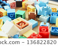 Colorful toy blocks are laid out on the background material. It can be used for presentations, slideshows, and corporate documents. 136822820