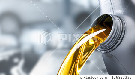 Pouring motor oil into the car engine Pouring motor oil into the car engine 136823353