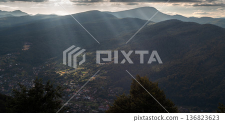 Mountain Valley with Sun Rays Breaking Through Clouds Mountain Valley with Sun Rays Breaking Through Clouds 136823623