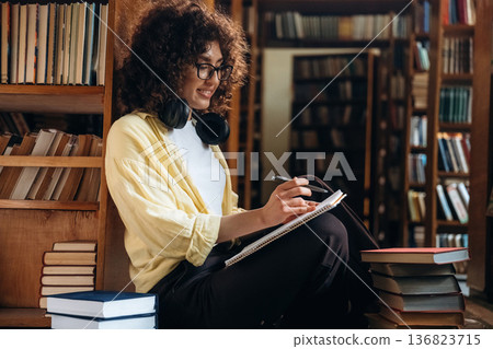 Beautiful woman is in the library Beautiful woman is in the library 136823715